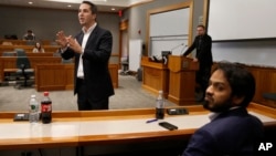 Lorenzo Vidino, of Milan, Italy, top left, director of the Program on Extremism at George Washington University, addresses an audience during a meeting titled "Resilience to Violent Extremism: Effective Intervention Approaches," at Suffolk Law School, in Boston, Nov. 10, 2015.