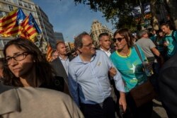 FILE - Catalan regional president Quim Torra, center, is seen during a pro-independence rally on Catalonia's National Day, in Barcelona, Spain, Sept. 11, 2019.