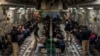 This image released by the Department of Defense shows undocumented migrants awaiting takeoff for a removal flight at the Tucson International Airport, Arizona, Jan. 23, 2025. (AFP photo / DVIDS / Department of Defense / Senior Airman Devlin Bishop) 