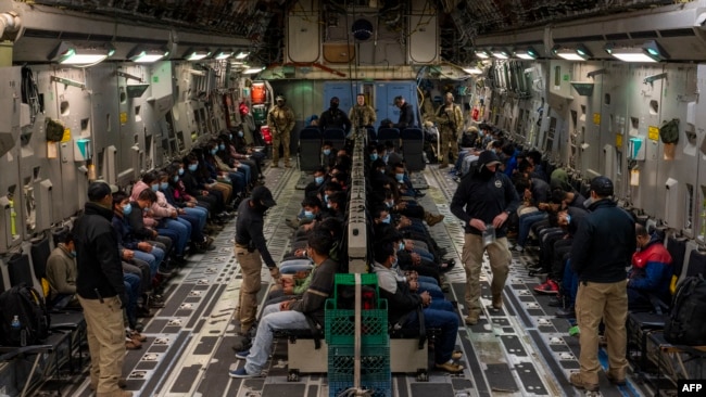 This image released by the Department of Defense shows undocumented migrants awaiting takeoff for a removal flight at the Tucson International Airport, Arizona, Jan. 23, 2025. (AFP photo/DVIDS/Department of Defense/Senior Airman Devlin Bishop)