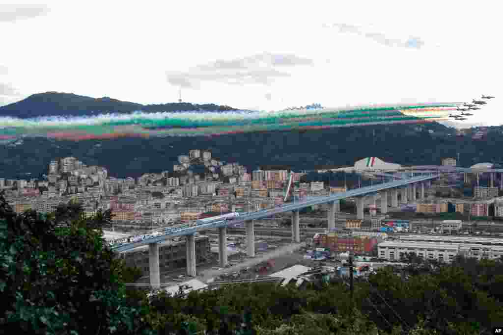 Italian Air Force aerobatic squad flies over the new San Giorgio Bridge during its inauguration in Genoa, Italy. A stretch of roadbed of the bridge collapsed two years ago, sending cars and trucks plunging to dry riverbed below and ending 43 lives.