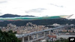 Italian Air Force aerobatic squad flies over the new San Giorgio Bridge during its inauguration in Genoa, Italy. A stretch of roadbed of the bridge collapsed two years ago, sending cars and trucks plunging to dry riverbed below and ending 43 lives.