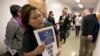 Teamster member Rocio Mejia, a supporter of a proposal to raise the state's minimum wage, joins others outside the Assembly Chambers calling for Assembly members to approve the measure, March 31, 2016, in Sacramento, California.