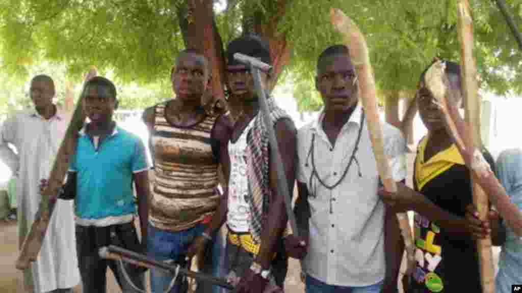 Wasu matasa 'yan banga suka tsaya don a dauki hotonsu a Maiduguri, 11 Yuni, 2013.