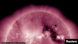 Image courtesy of NASA shows the planet Venus transiting the Sun, June 5, 2012. One of the rarest astronomical events occurs when Venus passes directly between the sun and Earth, a transit that won't occur again until 2117.