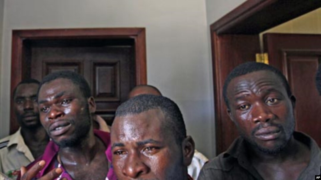 African migrant workers whom rebels accused of being mercenaries seen detained in a military base in Tripoli, Libya, Sunday, Aug. 28, 2011. Hundreds of migrant workers remain stranded in Libya after months of war unable to flee the country. (AP Photo/Serg