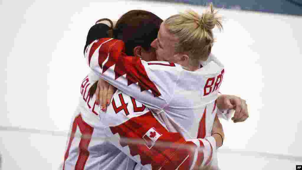 Bailey Bram of Canada, right, embraces Blayre Turnbull of Canada, after losing to the United States in the women's gold medal hockey game at the 2018 Winter Olympics in Gangneung, South Korea, Feb. 22, 2018.