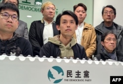 Lo Kin-hei, center, chairman of Hong Kong's Democratic Party, along with other senior leaders, attends a press conference at the party's headquarters in Hong Kong on Feb. 20, 2025.