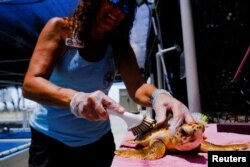 A Loggerhead turtle is cleaned at the Turtle Hospital, the first licensed veterinarian sea turtle hospital in the world, in Marathon, Florida, U.S., July 29, 2022. (REUTERS/Maria Alejandra Cardona)