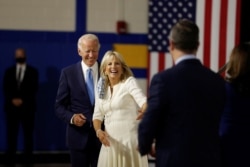 FILE - Democratic presidential candidate and former Vice President Joe Biden, his wife, Jill Biden, vice presidential candidate Senator Kamala Harris and her husband Douglas Emhoff are see in Wilmington, Delaware, Aug. 12, 2020.