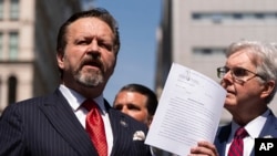 FILE - Sebastian Gorka, left, speaks during a press conference outside Manhattan criminal court on May 21, 2024, in New York. Gorka, now a senior U.S. counterterrorism official, said on Feb. 11, 2025, that the threat from jihadists is growing.