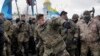 Mykola Kokhanivsky, commander of a volunteer battalion, throws a stone against the window of an office that belongs to Ukraine tycoon Rinat Akhmetov in Kyiv, Feb. 20, 2016. The activists blame Akhmetov for supporting corruption and pro-Russian separatists