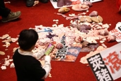 FILE - Pork intestines and other organs are seen on the ground after Taiwan lawmakers threw the parts at each other during a scuffle in the parliament in Taipei, Taiwan, Nov. 27, 2020.