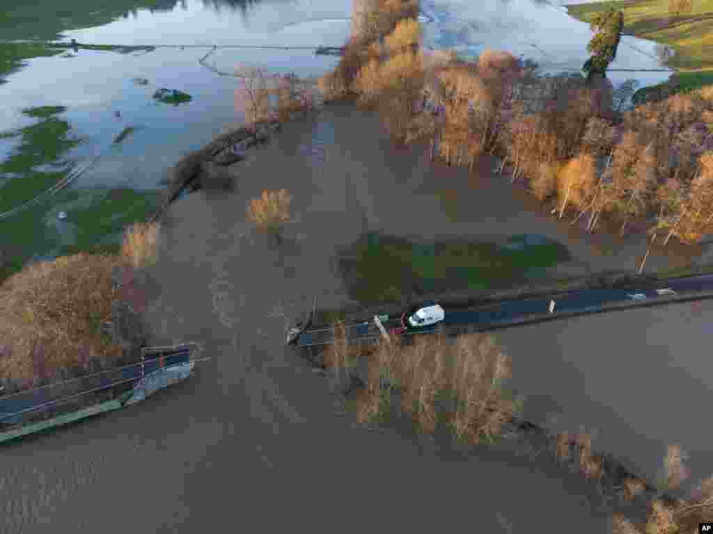 The Llanerch Bridge can be seen where a piece was ripped away above the flooded Clwyd River, near Saint Asaph in north Wales, after large parts of central and northern England and Wales were caught in the path of Storm Christoph, Saint Asaph, Wales.