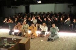 Actors and the audience hold up their hands at Budapest's Trafo threater in protest against a plan by Hungary's government to tighten its control over theaters in Budapest, Hungary, Dec. 8, 2019.