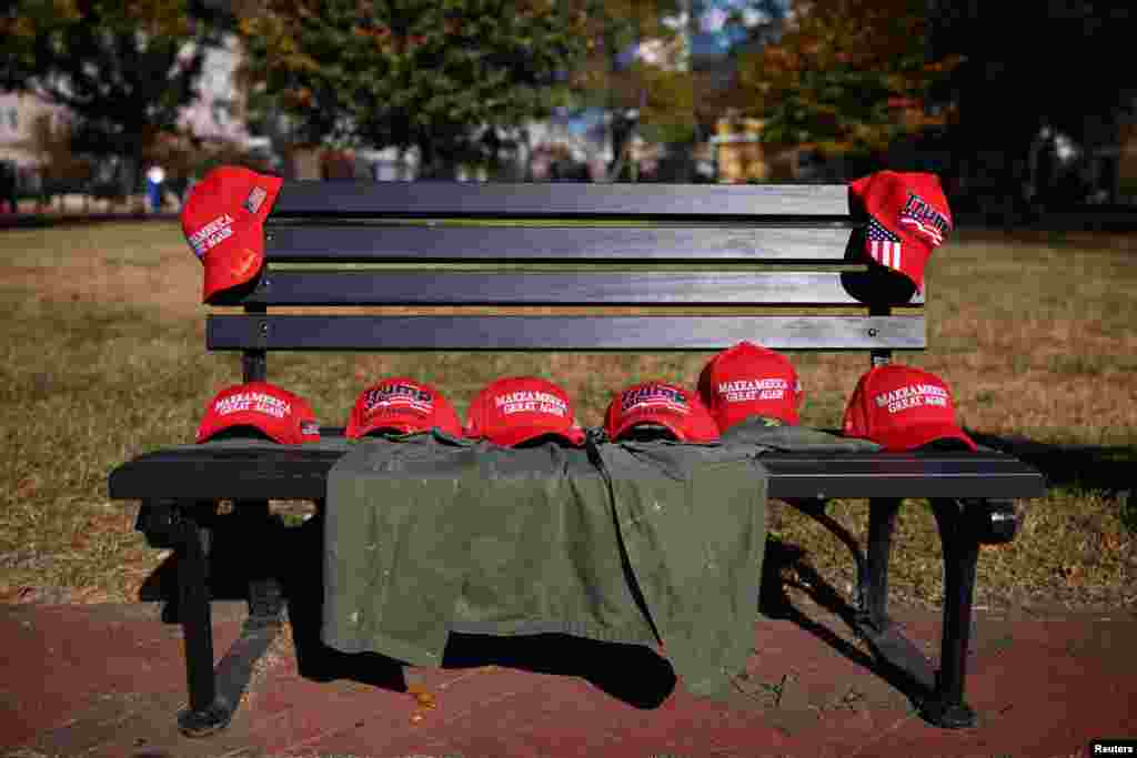 MAGA hats are laid out on a bench outside of the White House, after Republican Donald Trump won the U.S. presidential election, in Washington, D.C., Nov. 6, 2024. 