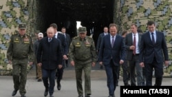 Russia's President Vladimir Putin (2nd L), Chief of the General Staff, Valery Gerasimov (R), and Defense Minister Sergei Shoigu (3rd L) attend the main stage of the Zapad 2021. (Mikhail Klimentyev/Russian Presidential Press and Information Office/TASS)