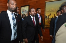 FILE - Ethiopia's Prime Minister Abiy Ahmed, center, arrives for an African Union summit in Addis Ababa, Ethiopia, Feb. 9, 2020. Ahmed on Nov. 4, 2020 ordered the military to confront the Tigray regional government after he said it attacked a base.