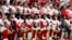 Members of the San Francisco 49ers kneel during the national anthem as others stand before the start of an NFL football game against the Arizona Cardinals, Oct. 1, 2017, in Glendale, Arizona.