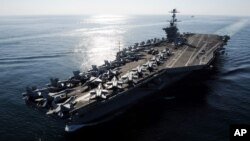 In this Nov. 12, 2011 photo provided by the U.S. Navy, the Nimitz-class aircraft carrier USS John C. Stennis (CVN 74) transits the Straits of Hormuz.