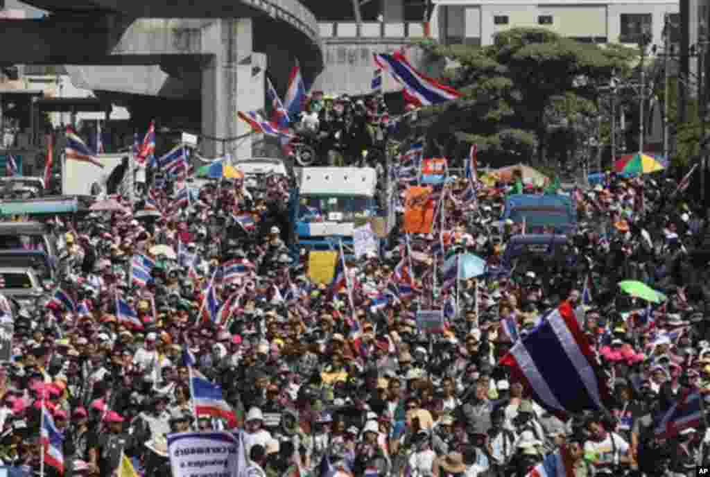 Anti-government protesters with national flags gather for a rally Monday, Jan. 13, 2014, in Bangkok, Thailand. Anti-government protesters took over key intersections in Thailand's capital Monday, halting much of the traffic into Bangkok's central business