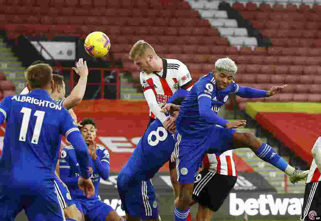 Sheffield United&#39;s Oliver McBurnie, top right, scores his side&#39;s opening goal during the English Premier League soccer match between Sheffield United and Leicester City, at the Brammall Lane Stadium in Sheffield, England.