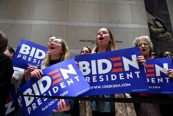 Supporters of Democratic presidential hopeful former Vice President Joe Biden cheers as he speaks at the National Constitution Center in Philadelphia, on March 10, 2020.