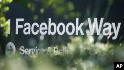 FILE - An address sign for Facebook Way is shown in Menlo Park, Calif, April 25, 2019.. 