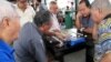 FILE - Elderly men spend their time of day playing Chinese checkers at Chinatown in Singapore. 