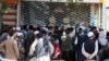 Afghans wait for hours to try to withdraw money, in front of Kabul Bank, in Kabul, Afghanistan, Saturday, Aug. 28, 2021. (AP Photo/Khwaja Tawfiq Sediqi)