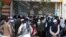 Afghans wait for hours to try to withdraw money, in front of Kabul Bank, in Kabul, Afghanistan, Saturday, Aug. 28, 2021. (AP Photo/Khwaja Tawfiq Sediqi)
