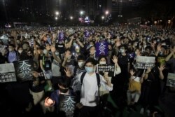 Participants gesture with five fingers, signifying the "Five demands - not one less" during a vigil for the victims of the 1989 Tiananmen Square Massacre in Hong Kong, June 4, 2020.