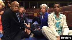 A photo tweeted from the floor of the U.S. House by Rep. Donna Edwards (R) shows Democratic members of the U.S. House of Representatives, including herself and Rep. John Lewis (L) staging a sit-in on the House floor. (REUTERS/Rep. Donna Edwards/Handout)