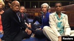 U.S. House Democrats including John Lewis, left, and Donna Edwards, right, stage a sit-in to demand action on gun legislation. Edwards tweeted the photo.