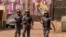 FILE: FILE - In this file photo taken on Saturday, March 7, 2015, armed forces provide security in Bamako, Mali. A new report says that armed groups in Mali are carrying out a growing number of attacks, and that the violence is taking place closer to the capital than ever.
