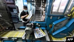 FILE - An employee works at the printing facility of the Apple Daily newspaper in Hong Kong, May 11, 2021.