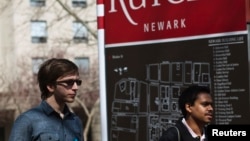 FILE - People walk on the Rutgers University campus in Newark, NJ, April 8, 2013.