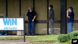 FILE - Clients line up outside the Mississippi Department of Employment Security WIN Job Center in Pearl, Aug. 31, 2020. 