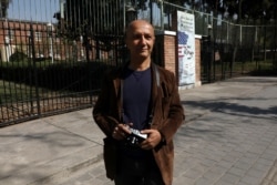 FILE - Veteran Iranian freelance photojournalist Kaveh Kazemi, who covered events following the U.S. embassy takeover in 1979, speaks with The Associated Press in front of the former embassy, in Tehran, Iran, Oct. 15, 2019.