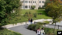 FILE - College students wear masks our of concern for the coronavirus on the Boston College campus, Sept. 17, 2020, in Boston.