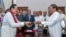 Sri Lanka's former President Mahinda Rajapaksa, front left, is sworn in as prime minister before President Maithripala Sirisena in Colombo, Sri Lanka, Oct. 26, 2018.