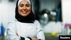 Syrian migrant Malakeh Jazmati poses for a picture in a kitchen of Cafe in Berlin, Germany, Jan. 23, 2018. 