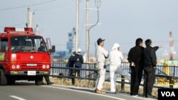 救火隊員和福島當地居民在海嘯預警之後觀察海水水位（2016年11月22日）