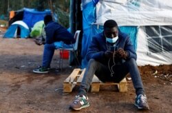 Two migrants are photographed together in the tents where they have lived for weeks in La Laguna, on the island of Tenerife, Spain, April 5, 2021.