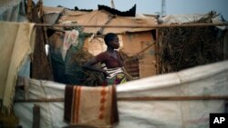 Christian refugees create a home for themselves in makeshift shelters near the airport in Bangui, Central African Republic, Tuesday Jan. 28, 2014, as they try to escape from the deepening divisions between the country's Muslim minority and Christian major