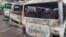 FILE - Burned buses are seen at the bus terminal in Buea, Cameroon, after gunfire broke out, July 9, 2018.