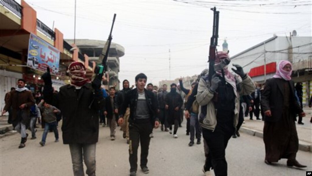 Warga menyerukan slogan-slogan anti pemerintah yang dikuasai kelompok Syiah di Irak dalam sebuah upacara pemakaman seorang pria yang tewas dalam bentrokan antara militan al-Qaida dan polisi di Fallujah (4/1). 