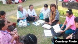 Im Chaem, center, wearing a white shirt sits with a group of women in a Bible study session, Battambang province, Cambodia, January 22, 2018. (Courtesy photo of pastor Touch Chanthou)