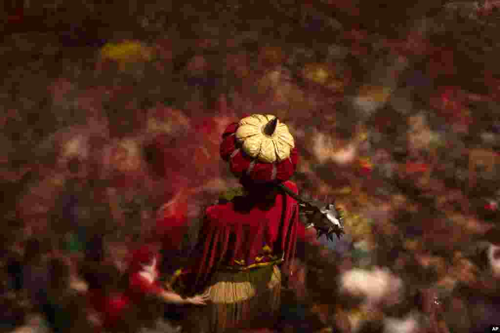 A figure of a giant stands as revellers dance during the Patum in the Catalan village of Berga, Spain, June 4, 2015. The Patum of Berga is a popular festival whose origin can be traced to medieval festivities that is celebrated each year in the Catalan city of Berga during Corpus Christi.