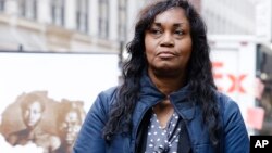 Tamara Lanier attends a news conference near the Harvard Club, March 20, 2019, in New York. Lanier is suing the Harvard University for "wrongful seizure, possession and expropriation" of images she says depict two of her ancestors.